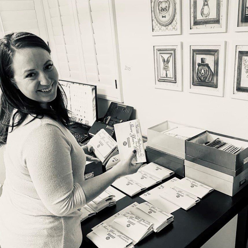 Michelle organizing printed family photographs and keepsakes for digitization
