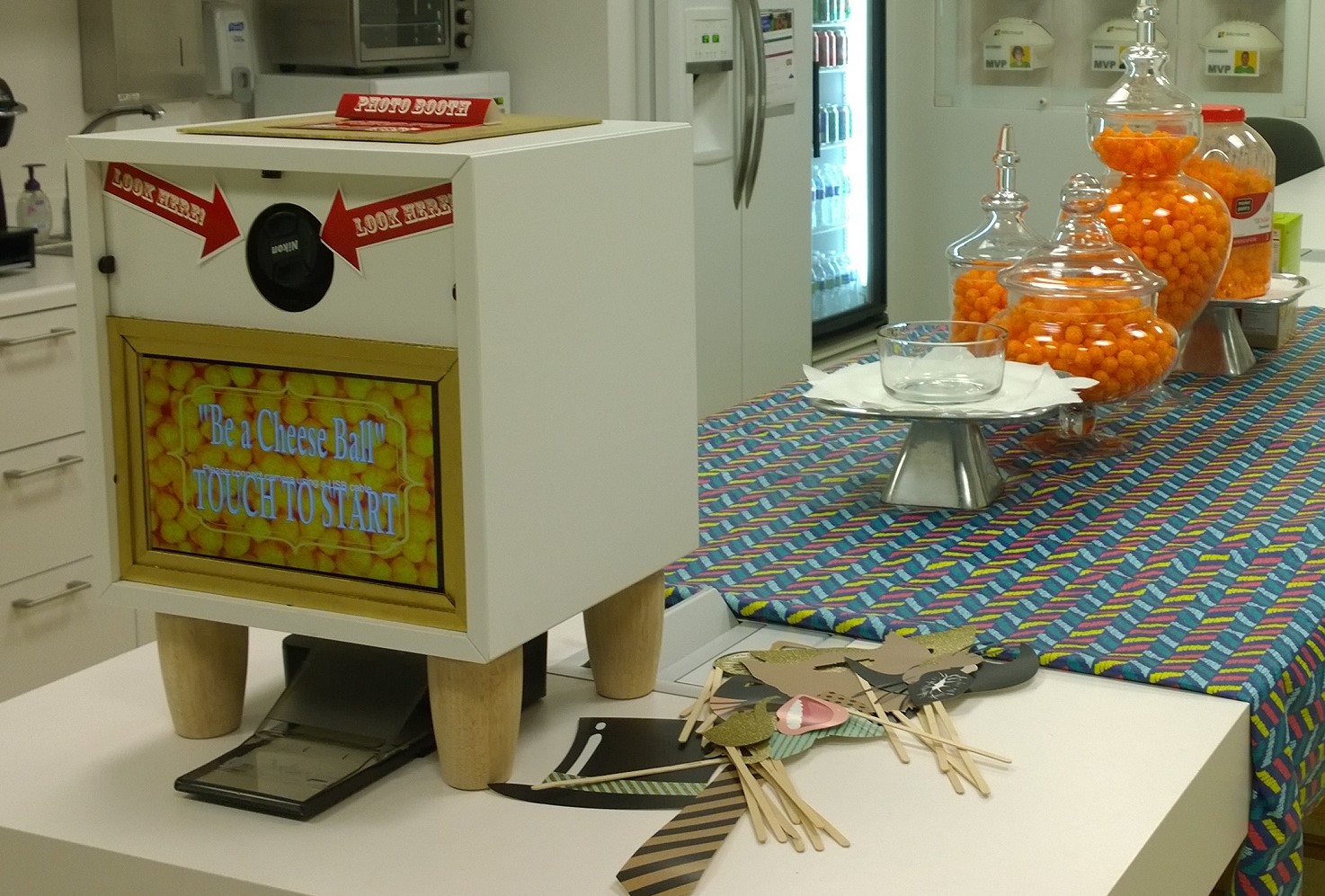 Custom white photo booth with touch screen and props